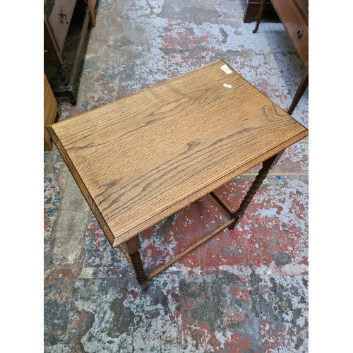 494 - An oak rectangular side table on barley twist supports