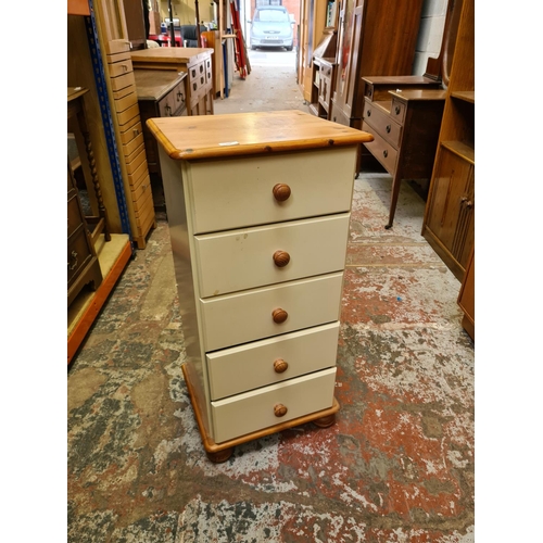 496 - A modern pine effect and cream painted chest of five drawers