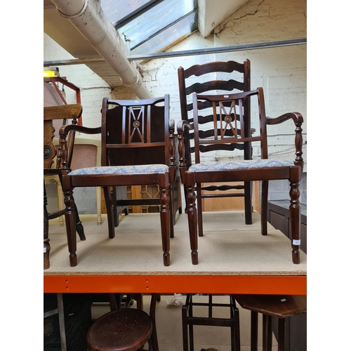 505 - A pair of mahogany carver dining chairs with blue floral upholstery