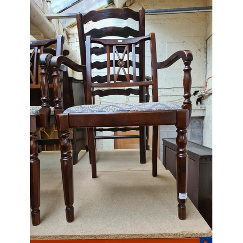 505 - A pair of mahogany carver dining chairs with blue floral upholstery