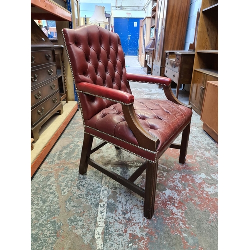 509 - A vintage Chesterfield style red leather desk chair