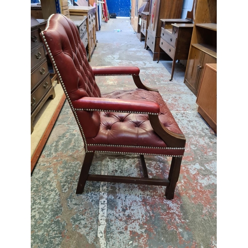 509 - A vintage Chesterfield style red leather desk chair