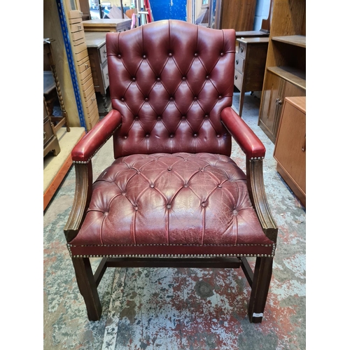 509 - A vintage Chesterfield style red leather desk chair