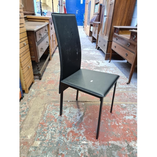 511 - Four modern black leatherette dining chairs on black metal supports