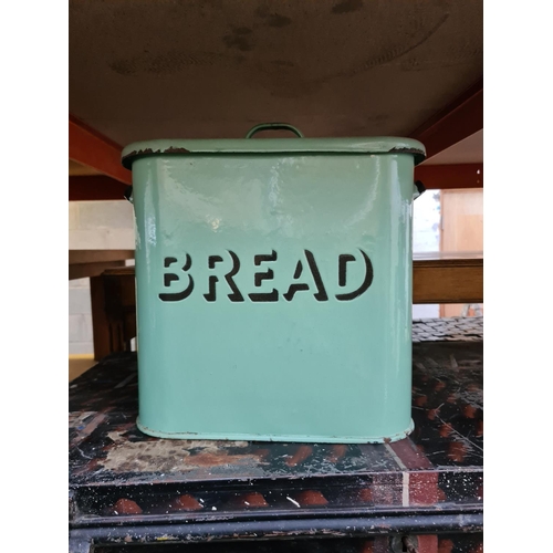 515 - Three items to include a vintage black painted R.A.F travel trunk with key, green enamel bread bin a... 