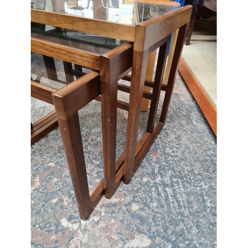 516 - A teak nest of three tables with smoked glass inserts and a modern bentwood stool