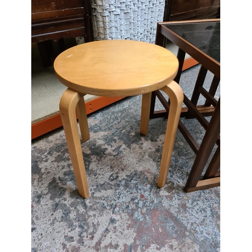 516 - A teak nest of three tables with smoked glass inserts and a modern bentwood stool