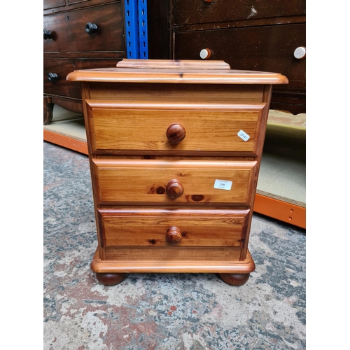 518 - A modern pine three drawer bedside cabinet