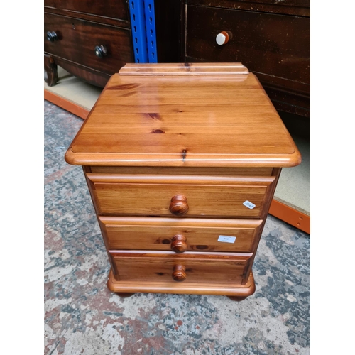 518 - A modern pine three drawer bedside cabinet