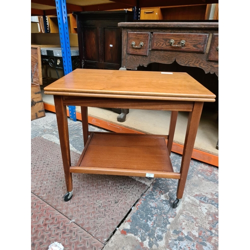 521 - A mid 20th century Eastcraft of Scotland teak two tier fold out games trolley with green baize top