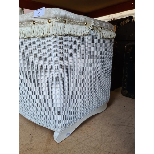 526 - A Lloyd Loom style white painted wicker ottoman with white upholstered top and contents