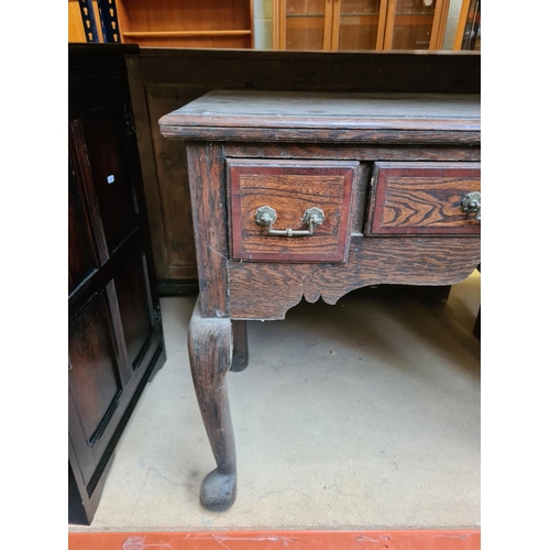 534 - An Edwardian oak writing table on cabriole supports with three drawers - measuring approx. 77cm high... 