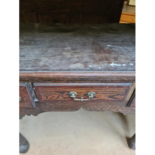 534 - An Edwardian oak writing table on cabriole supports with three drawers - measuring approx. 77cm high... 