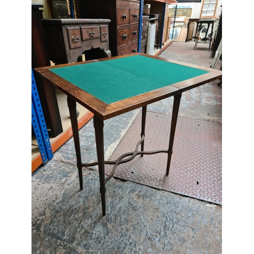 540 - An early 20th century German mahogany folding games table with green baize top