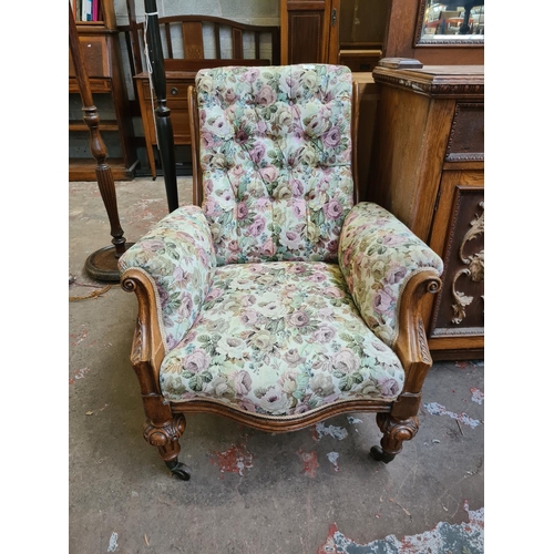 544 - A Victorian heavily carved oak parlour chair with later added floral upholstery