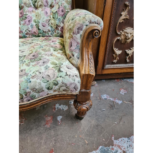 544 - A Victorian heavily carved oak parlour chair with later added floral upholstery