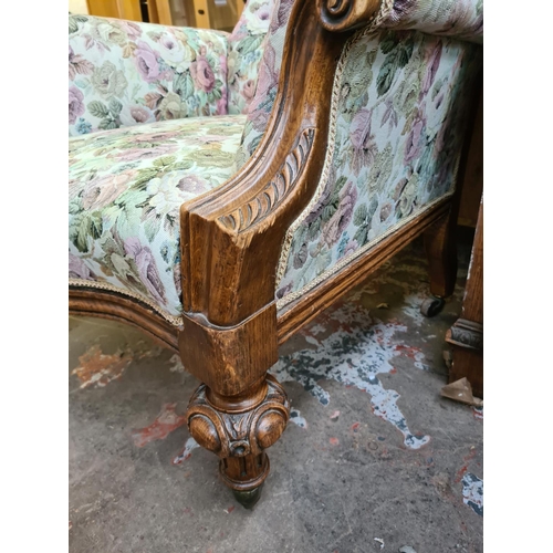 544 - A Victorian heavily carved oak parlour chair with later added floral upholstery