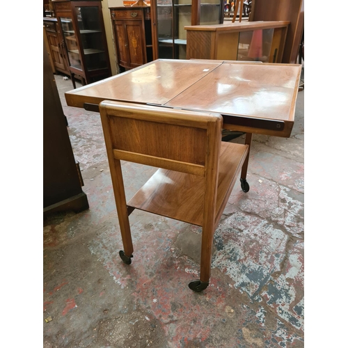 547 - A mid 20th century walnut two tier metamorphic tea trolley