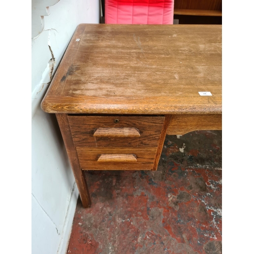 548 - A vintage oak office desk with four drawers