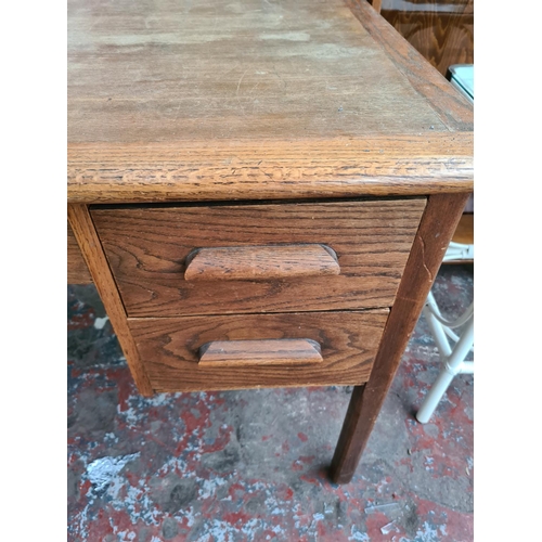 548 - A vintage oak office desk with four drawers