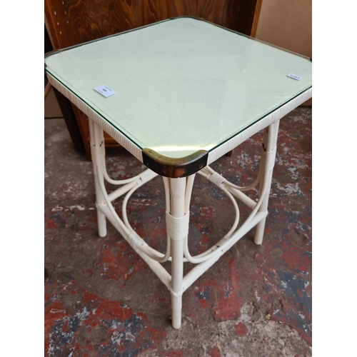 549 - Two items to include a vintage Lloyd Loom style white painted side table with glass top and a vintag... 