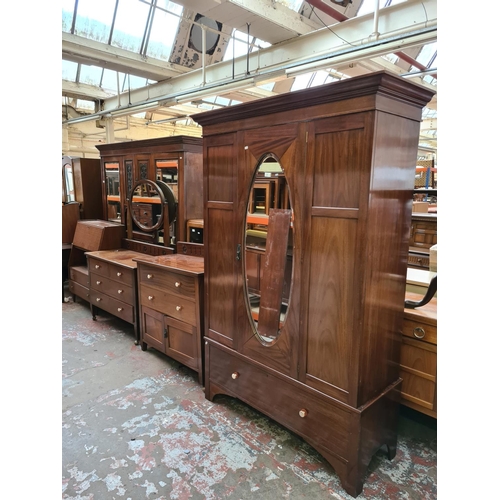 552 - An Edwardian mahogany three piece bedroom suite comprising single door wardrobe with oval bevel edge... 