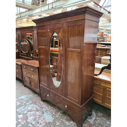 552 - An Edwardian mahogany three piece bedroom suite comprising single door wardrobe with oval bevel edge... 