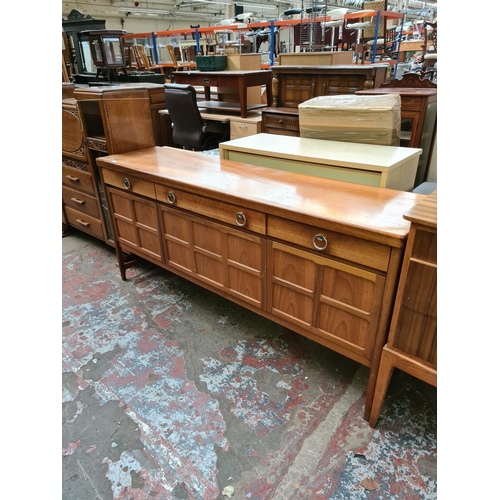 567 - A Nathan teak sideboard with three drawers and two outer cupboard doors and central fall front (see ... 