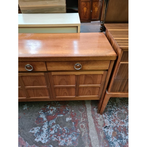 567 - A Nathan teak sideboard with three drawers and two outer cupboard doors and central fall front (see ... 