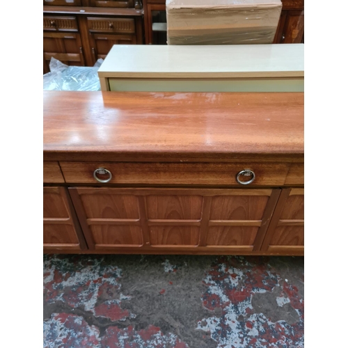 567 - A Nathan teak sideboard with three drawers and two outer cupboard doors and central fall front (see ... 