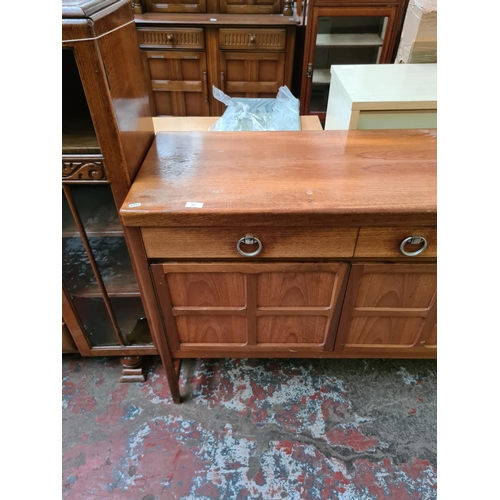 567 - A Nathan teak sideboard with three drawers and two outer cupboard doors and central fall front (see ... 