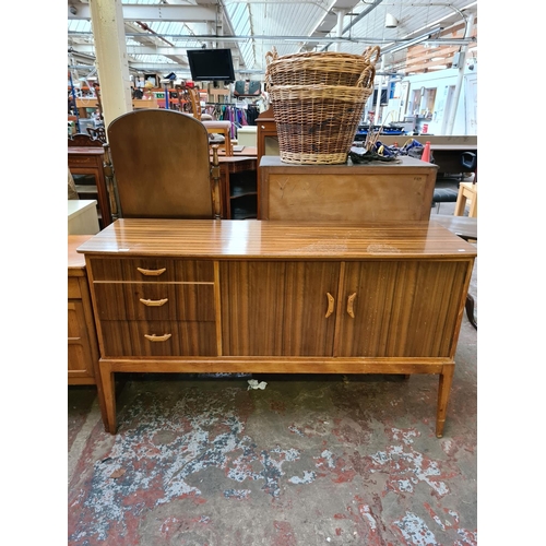 569 - A mid 20th century Hopewells walnut and beech sideboard with two cupboard doors and three drawers (s... 