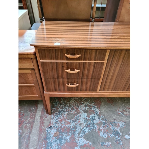 569 - A mid 20th century Hopewells walnut and beech sideboard with two cupboard doors and three drawers (s... 