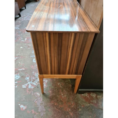 569 - A mid 20th century Hopewells walnut and beech sideboard with two cupboard doors and three drawers (s... 