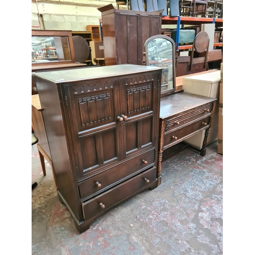 571 - Two items to include a Priory style oak cabinet with two doors and two drawers and a matching dressi... 