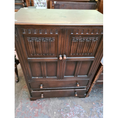 571 - Two items to include a Priory style oak cabinet with two doors and two drawers and a matching dressi... 