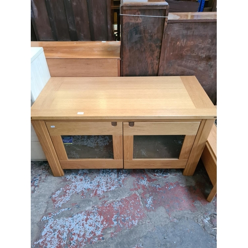 574 - An Exigence oak TV stand with two glazed doors (matches lots 465, 575 and 576)