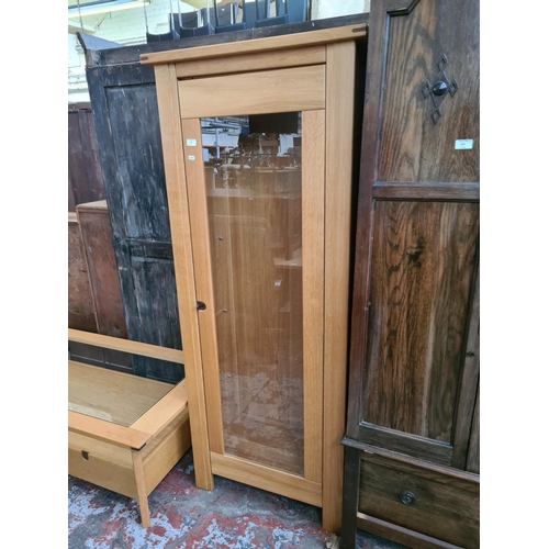 576 - An Exigence oak display cabinet with one glazed door and key (matches lots 465, 574 and 575)