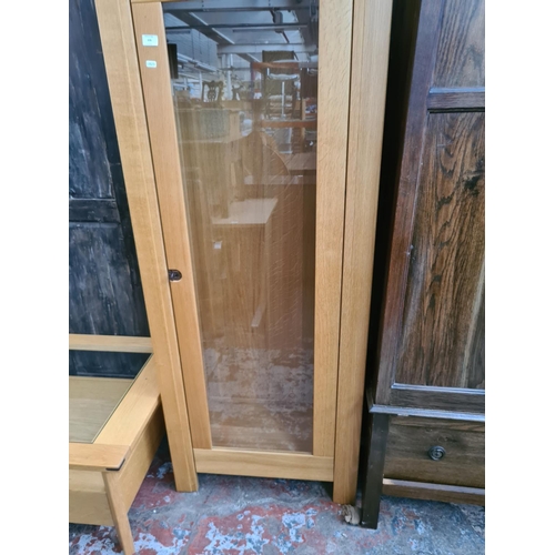 576 - An Exigence oak display cabinet with one glazed door and key (matches lots 465, 574 and 575)