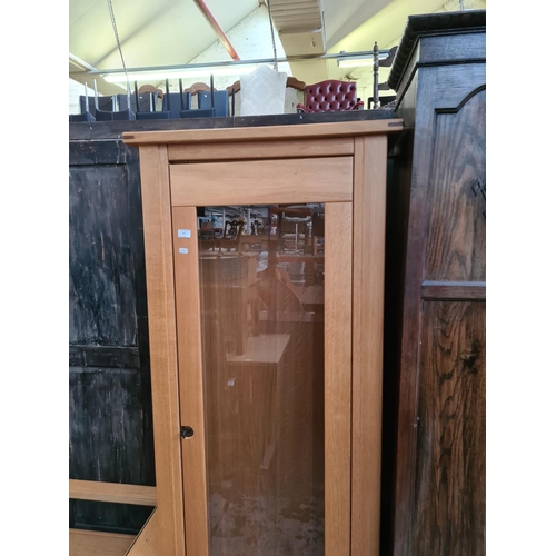 576 - An Exigence oak display cabinet with one glazed door and key (matches lots 465, 574 and 575)