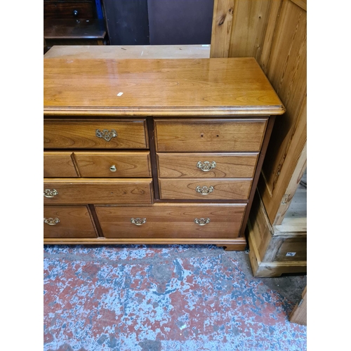 582 - A teak effect sideboard with nine drawers (see condition report)