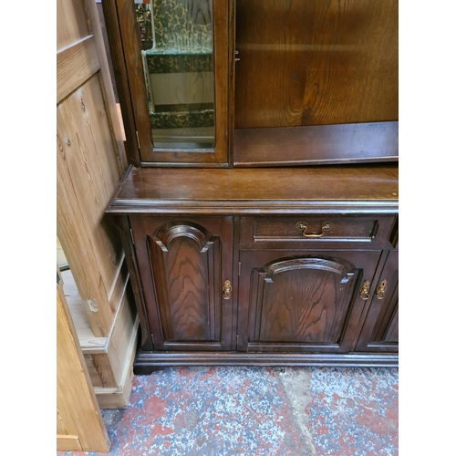 584 - An oak dresser with two upper glazed doors, four lower drawers and two doors