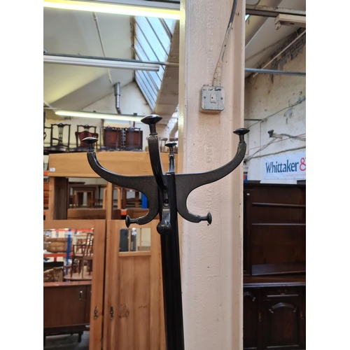 587 - A modern black metal two section coat stand