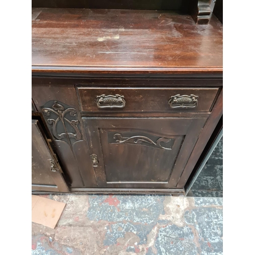 589 - An Edwardian mahogany mirrored back sideboard with corinthian column supports, Art Nouveau type hand... 