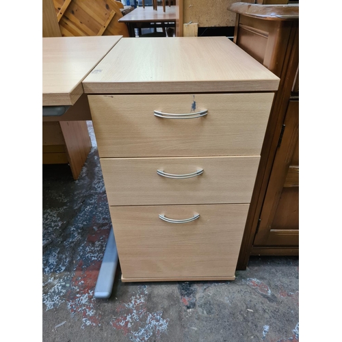 594 - A modern beech effect office desk and matching three drawer office cabinet