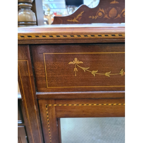 597 - An Edwardian inlaid mahogany display cabinet on tapering supports with one glazed door and key