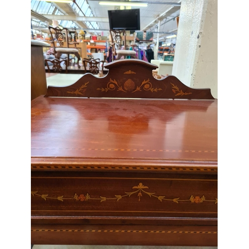 597 - An Edwardian inlaid mahogany display cabinet on tapering supports with one glazed door and key