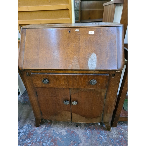 620 - Two items to include an Edwardian mahogany hall stand with bevel edged mirror, four coat hooks, glov... 