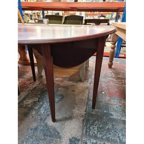 627 - A mid 20th century mahogany drop leaf dining table on tapering supports (see condition report)