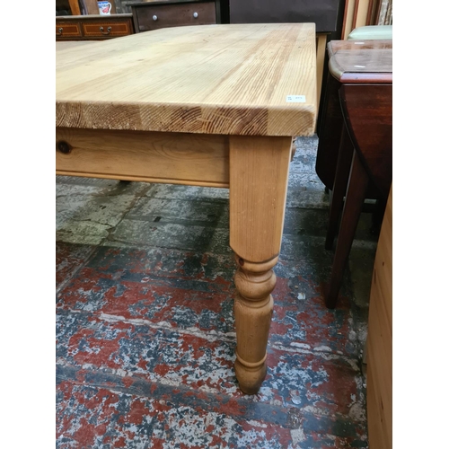 629 - A solid pine rectangular farmhouse dining table - measuring approx. 183cm x 91cm x 78cm